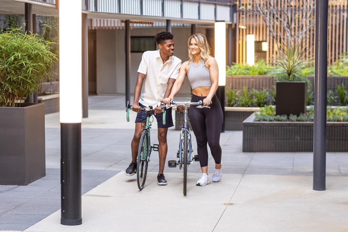 Couple_walking_with_bike_in_Courtyard_of_Luxury_Apartments_&_Townhomes_in_West_Hollywood